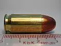 Side on view of Sellier & Bellot .45 ACP FMJ cartridge with ruler for scale.