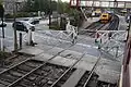 Ramsbottom level crossing gates being opened to road traffic after the passage of a train.