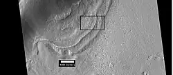 Context for the next image of the end of a flow feature, also called a lobate debris apron. It is probably a glacier. Location is Hellas quadrangle.