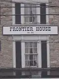 The official title of the house located between two windows on the front of the structure.