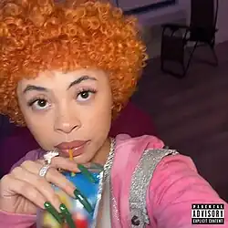 Selfie of Ice Spice drinking from a pouch of beverage (brand censored)