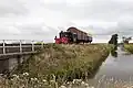 Köf locomotive pulling cargo coaches