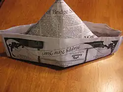 The newspaper hat worn by Večerníček