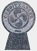 A lauburu and text 'Memory'.