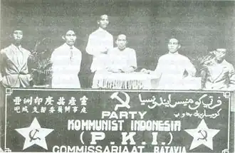Six men behind a banner