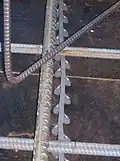 Plastic strip bar chairs supporting heavy rebar on suspended slab.
