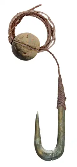 Stone fishing hook and sinker (a grooved pebble), used on Lake Hula in the Northern District of Israel during the Late Epipalaeolithic[21]