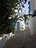 Typical street with white walls and blue window shades