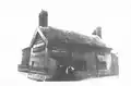 The predecessor to today's structure, named the Thatched House Tavern, pictured around 1880. Landlord Nicholas Charnock is likely the person on the right