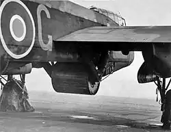 Upkeep bouncing bomb in position in the bomb bay of Guy Gibson's Lancaster – serial ED932/G, code 'AJ-G'